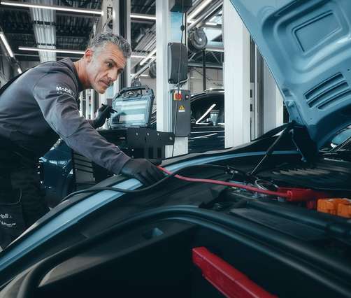 Technician working on a European vehicle engine